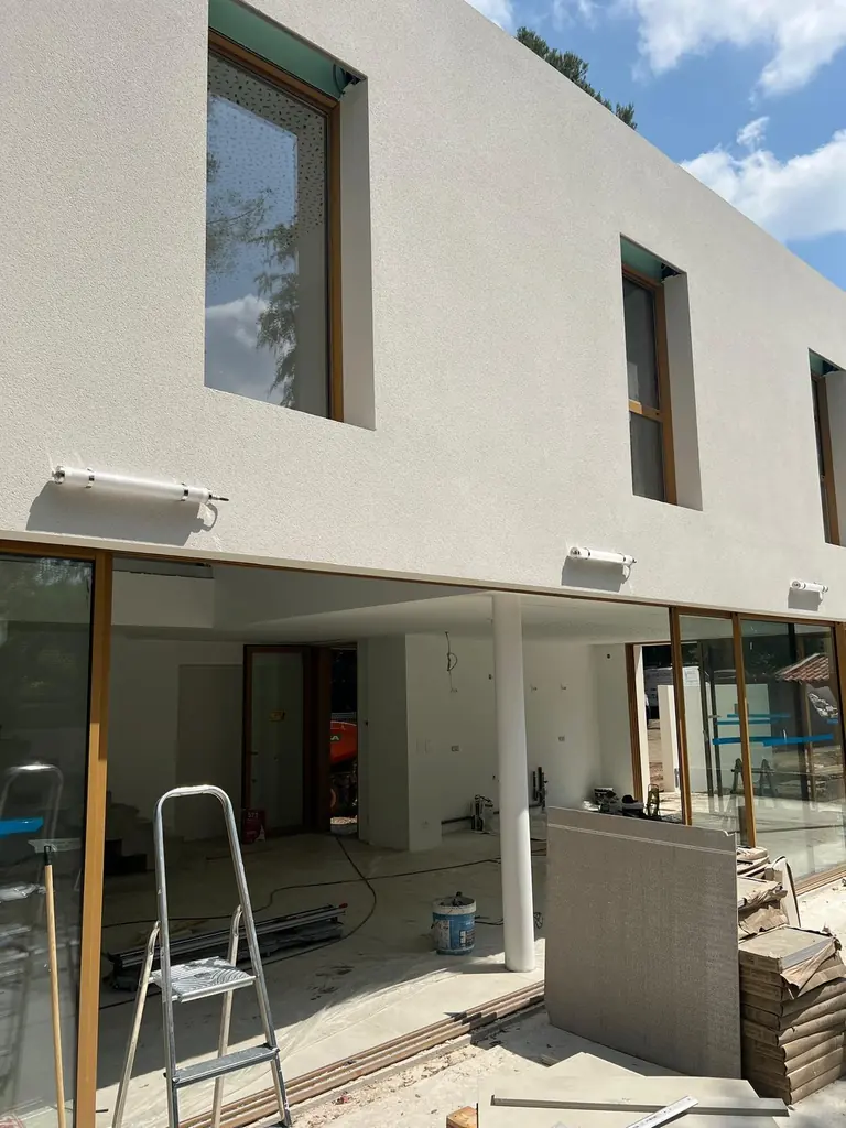 Façade contemporaine avec luminaires extérieurs posés, chantier en cours