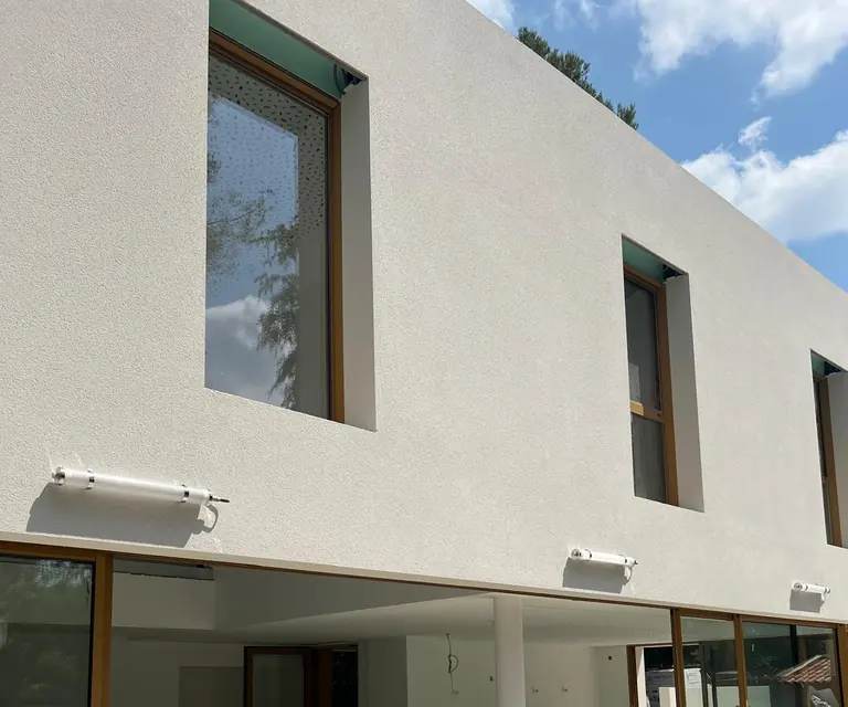 Façade d’une construction contemporaine avec luminaires extérieurs installés